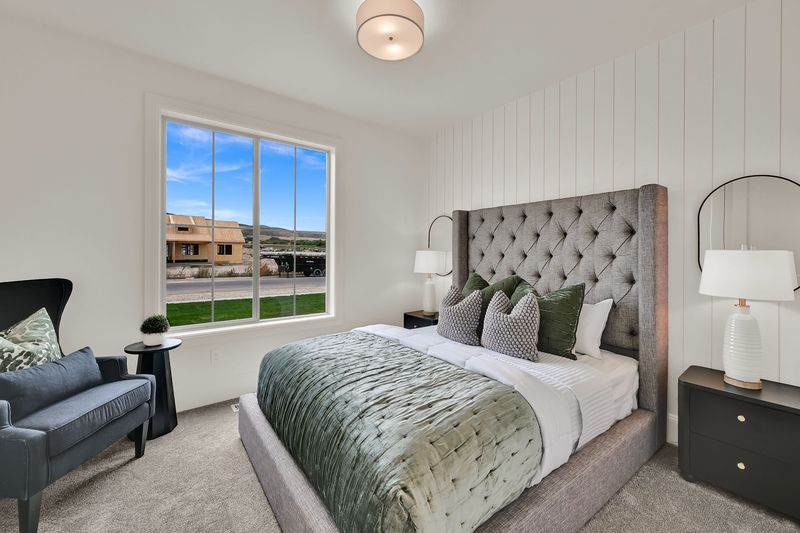 Secondary bedroom with a board-and-batten wall and a tufted headboard