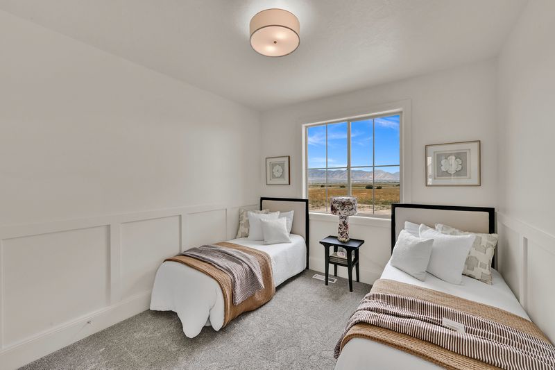 Third bedroom with panelled wainscot and windows onto the valley