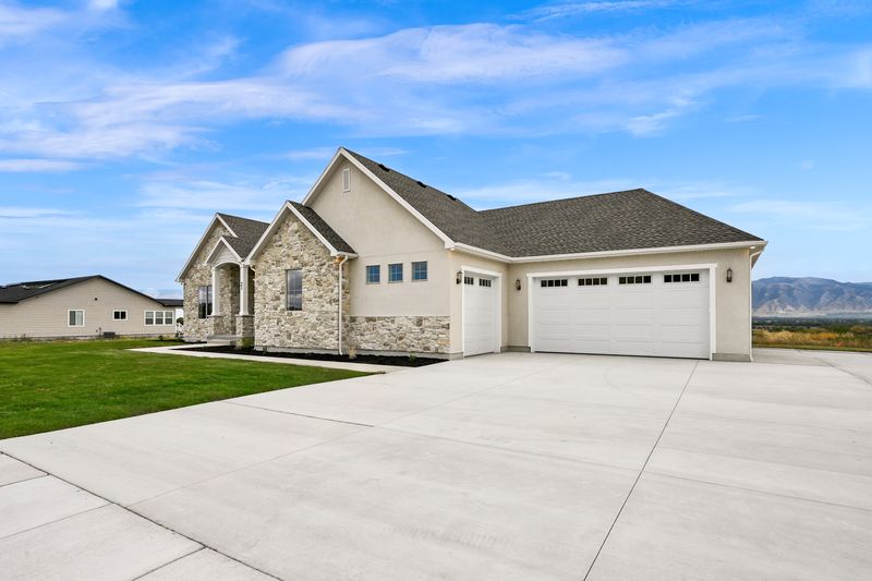 Driveway leading to the three-car garage along the side of the home