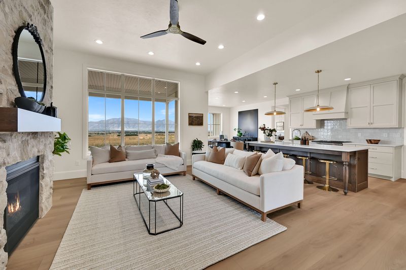 Open living area looking from the fireplace across the great room to the kitchen island