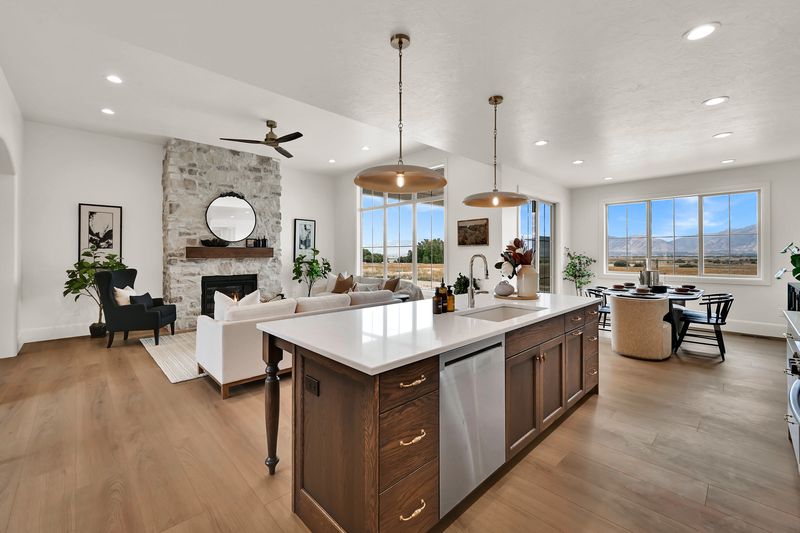 Kitchen looking back across the island toward the great room fireplace
