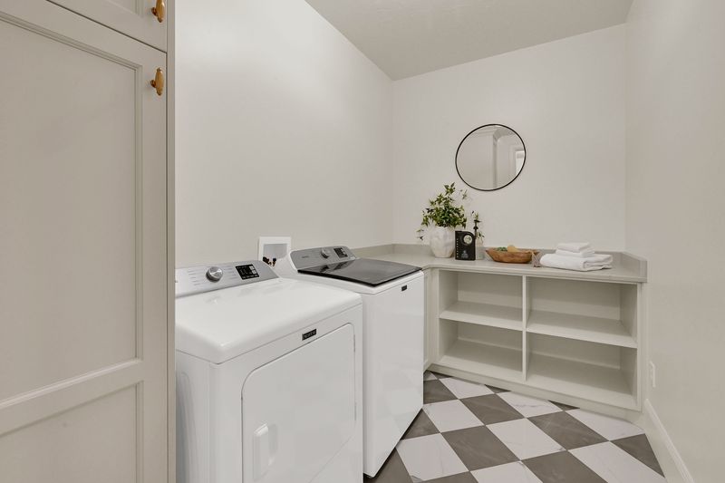 Laundry room with a checkerboard floor, folding counter and open shelving
