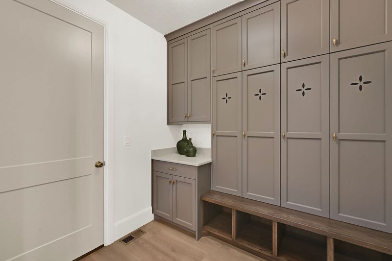Mud room off the garage with built-in lockers, a bench and cubbies