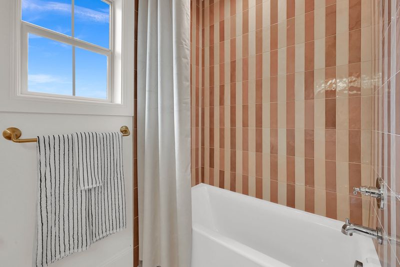 Tub and shower finished in vertical terracotta tile