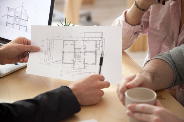 A couple reviewing home plans during an initial consultation